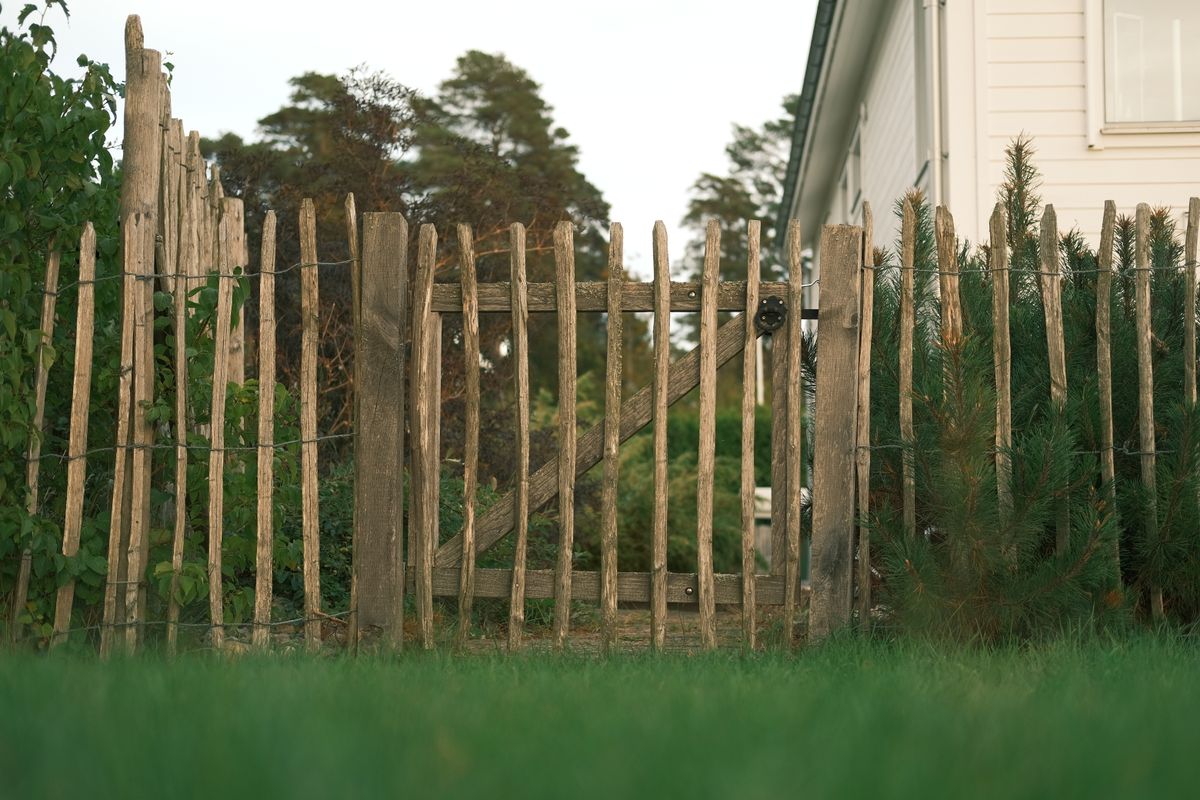 Fence surrounding a landscaped yard